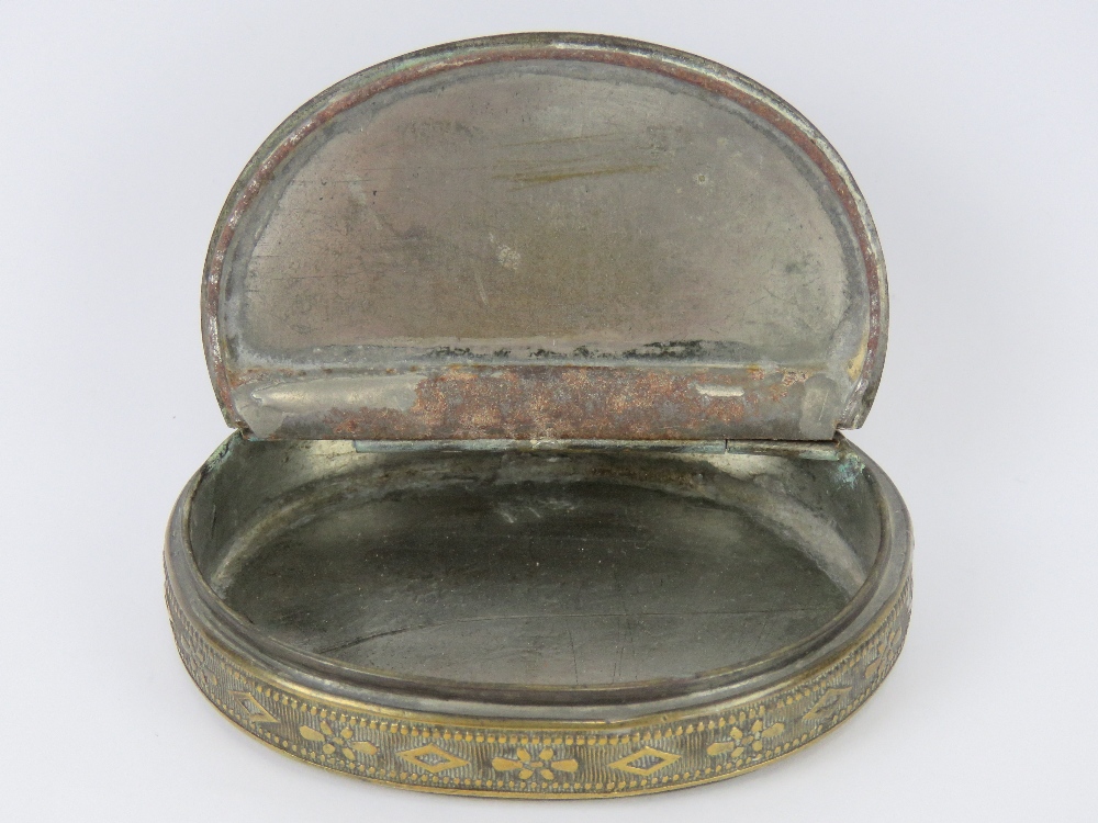 A brass snuff box of oval form with hinged lid, 8cm wide. Together with a cigar cutter. Two items. - Image 2 of 3