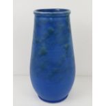 A matt blue pottery vase marked Barnstaple to base and numbered 394, standing 23.5cm high.