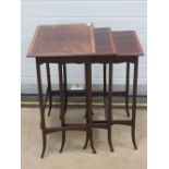 A good Edwardian nest of three mahogany tables each crossbanded with walnut and raised over slender