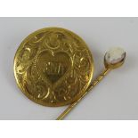 A circular yellow metal brooch having engraved floral decoration, pin a/f,
