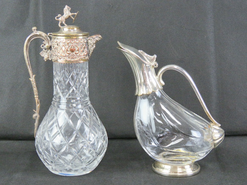A good heavy cut glass and silver plated claret jug having lion and shield finial, 31.5cm high.