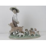 Lladro figurine 6828 'My Little Explorers' a boy walking with dog and five puppies following behind,