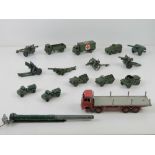 A quantity of Dinky toys and Britains army vehicles and artillery in play-worn condition.