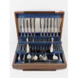 A large wooden canteen of silver plated cutlery for twelve sittings including carving set,