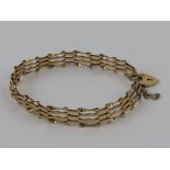 A 9ct gold 4-bar bracelet having heart padlock clasp,