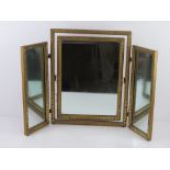 A gold painted tryptic dressing table mirror 50.5cm high, approx 63cm wide when standing.