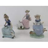 Two Nao LLadro figurines, girl on wheelbarrow with bird in hand 18cm high,