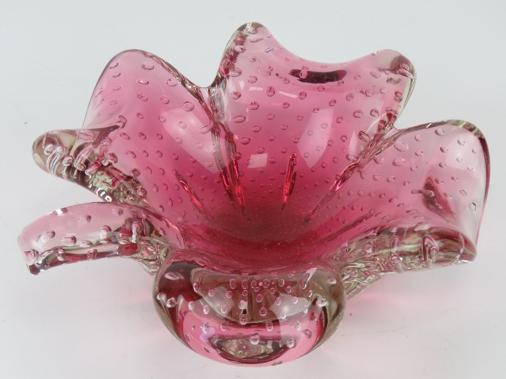An art glass bowl in the form of a four leave clover, pink ground, having bubble pattern throughout.