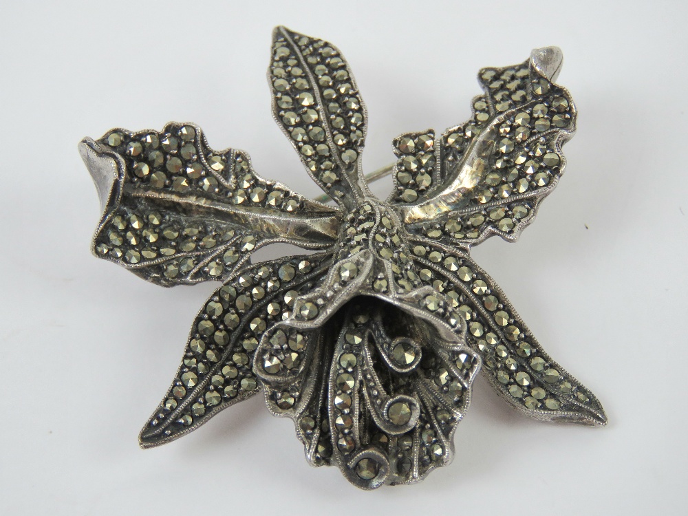 A vintage silver and marcasite brooch in the form of an orchid, 5cm wide, 26.6g.