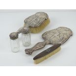 A delightful Art Nouveau HM silver dressing table hand mirror and hairbrush,