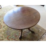 A circular occasional table raised over