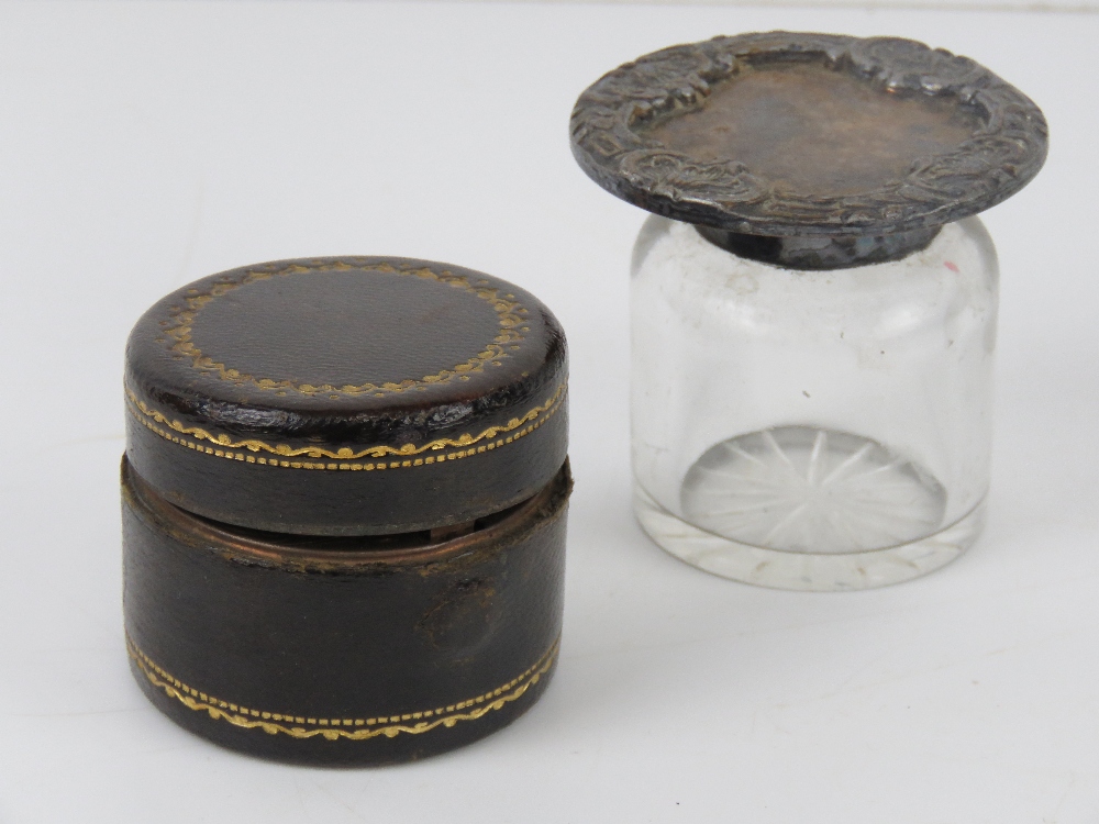 A leather and brass travelling inkwell o