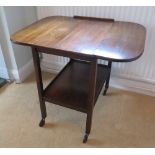 A c1950s drop leaf wheeled tea trolley w