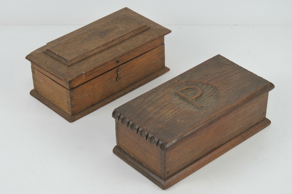 Two lidded oak boxes, one having P carve