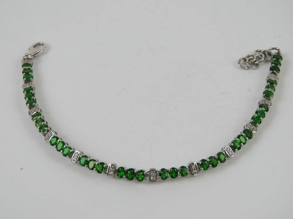 A silver tennis bracelet set with green - Image 2 of 2