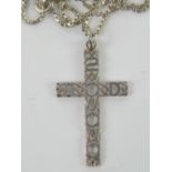 A white metal crucifix pendant having Ce