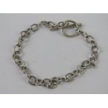 An HM silver charm bracelet having T-bar