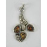 A Baltic amber floral pendant, no appare