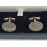 A pair of unengraved silver cufflinks in