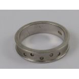 A silver band set with five diamonds, ri