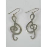 A pair of earrings in the form of treble