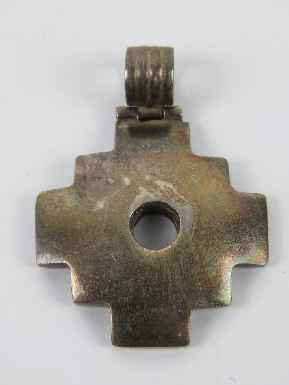 An unusual white metal pendant having cr