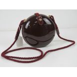 A c1960s Italian pop art style purse in burgundy, marked for Diva, 15cm diameter.