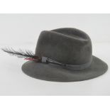 Marida; a 100% fur felt Trilby with decorative feathers upon, approx size 6 3/4.