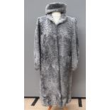 A vintage curly Persian lamb wool coat with matching hat,