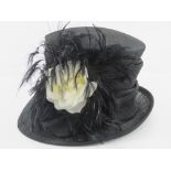 A Victoria Ann natural fibre hat having faux flower and feather design. Approx size 7.