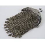 A white metal chain link purse having ch