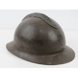 A French 1939-1943 helmet having liner and chin strap, badges removed.