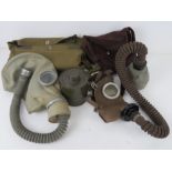 A Czech M-52 gas mask with filter in bag. Together with a Belgium L702 gas mask with filter in bag.