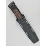 A USMC (US Marine Corp) KA BAR dagger with sheath.