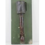 An inert WWI German stick grenade, mounted on board for display purposes, board measuring 42 x 18cm.