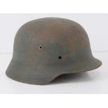 A WWII German helmet, liner deficient.
