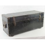 A black painted lidded trunk with clasps and end handles, 82 x 32 x 37cm.