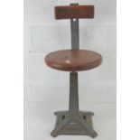 An elm top Singer (sewing machine) square shaped tapering stool with sprung back, seat 36cm dia,