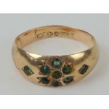 A 9ct gold Chester hallmarked Gypsy ring set with green stones in floral motif, size M-O, 1.6g.