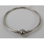 A silver Pandora charm bangle, stamped 925 ALE, 6cm internal dia, in presentation box.