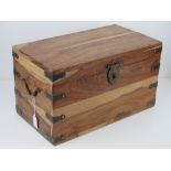 A contemporary wooden chest having iron stud work, end handles and latch, measuring 45 x 25.