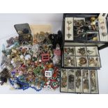 A large black leatherette jewellery box containing a quantity of assorted vintage jewellery,