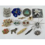 A quantity of 20th century brooches including an 835 silver and marcasite bar brooch, spider,