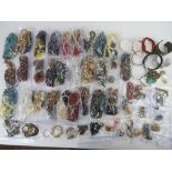 A quantity of assorted jewellery including glass beads necklaces, hard stone necklaces, bangles,