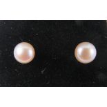 A pair of 9ct and pale pink pearl earrings with butterfly backs, stamped 9ct.