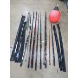 A large quantity of vintage fishing rods, nets etc. Including a fluorescent marker buoy.