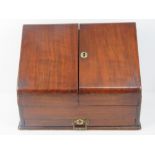 A mahogany stationary box opening to reveal pigeon holes within,