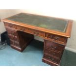 A contemporary Victorian style kneehole desk, leather writing surface,