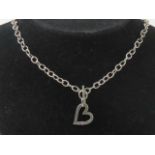 A HM silver necklace having heart pendant set with pink stone upon, T-bar clasp hallmarked 925,