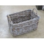 A large wicker work log basket having twin handles, 73 x 48 x 52cm.